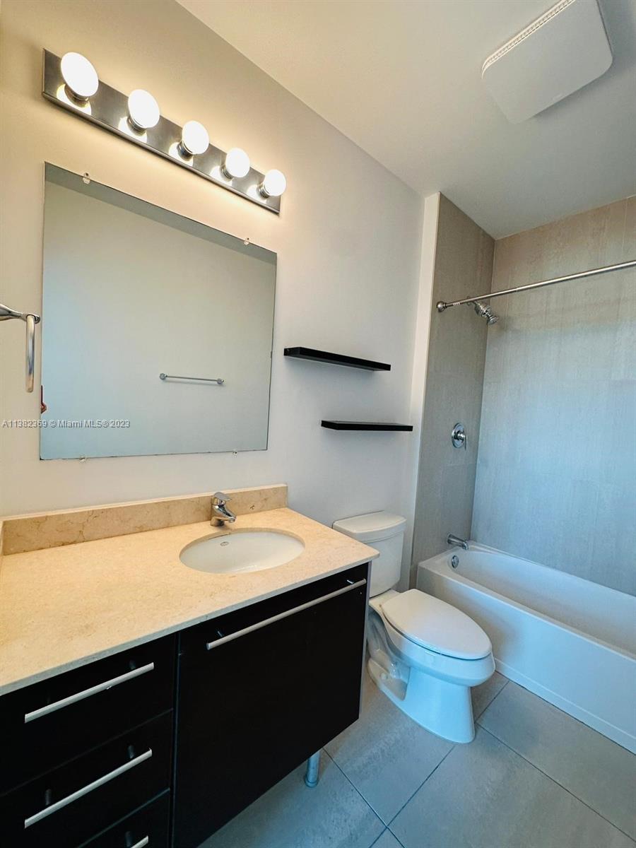 Edgewater Miami, FL 33132 - Photo 18 of 25 a bathroom with a sink a toilet and a mirror