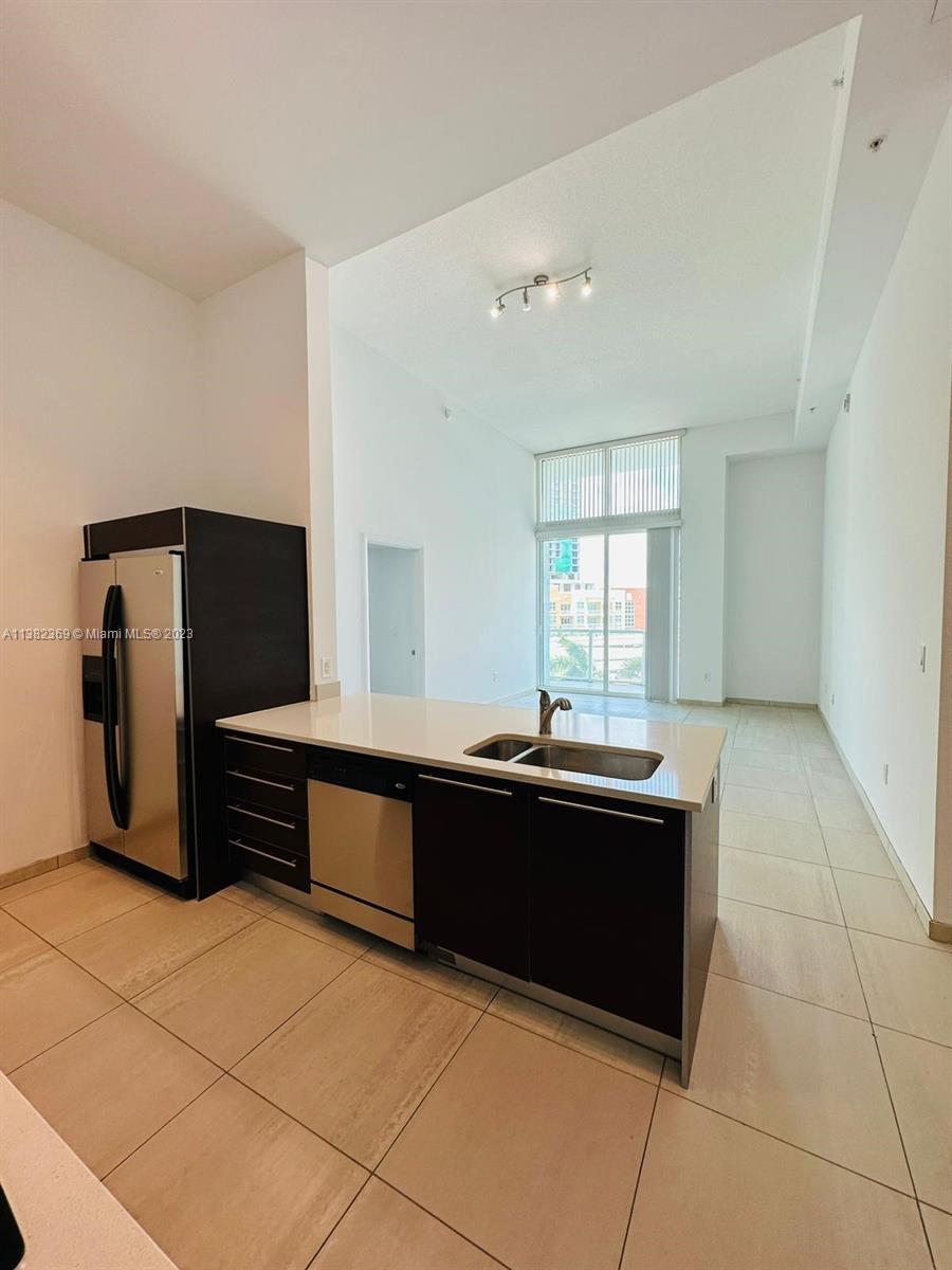 Edgewater Miami, FL 33132 - Photo 9 of 25 a room with a black and white checkered floor