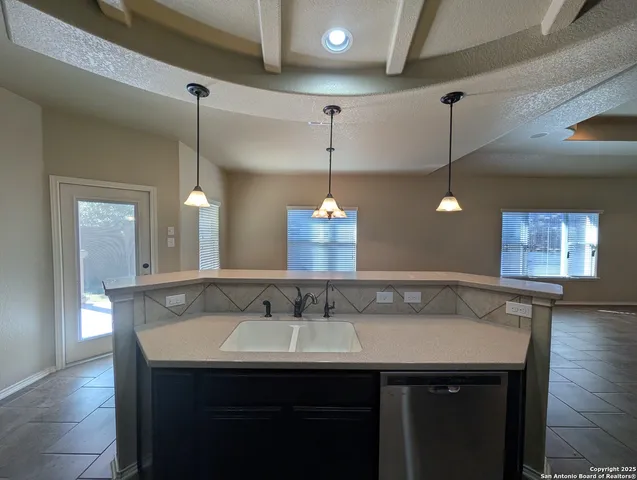 a bathroom with a sink and a wooden floor