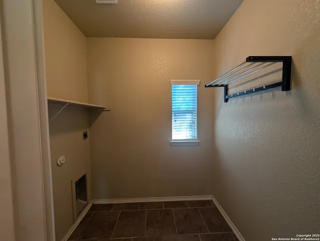 a view of storage and utility room with racks on the wall