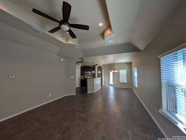 an empty room with projector and windows