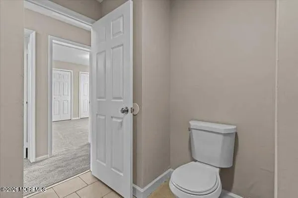 a white toilet sitting next to a bathroom sink
