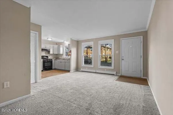 a view of a kitchen with refrigerator and window