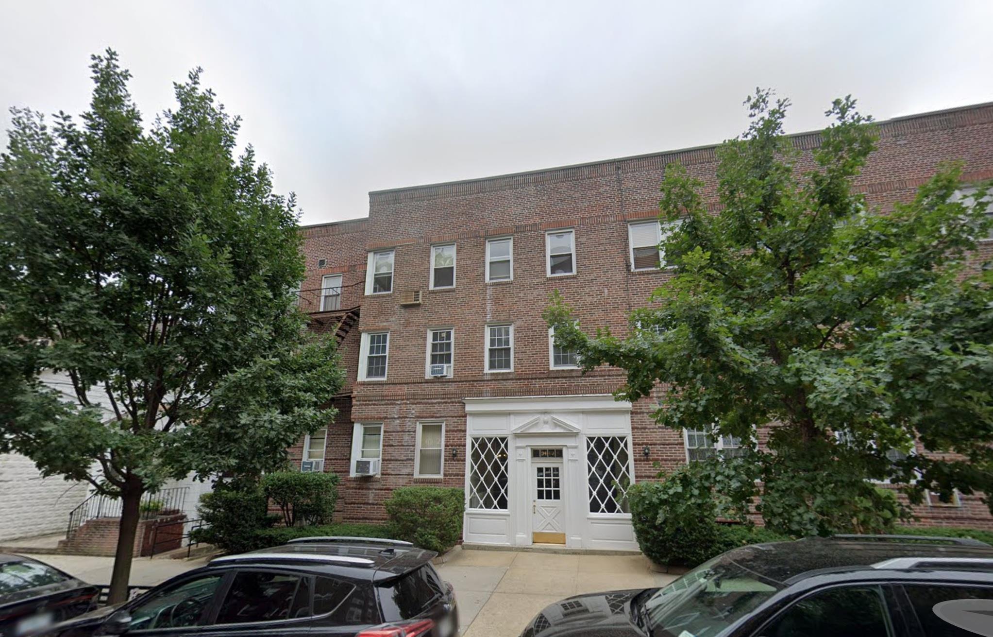 a front view of a house with trees