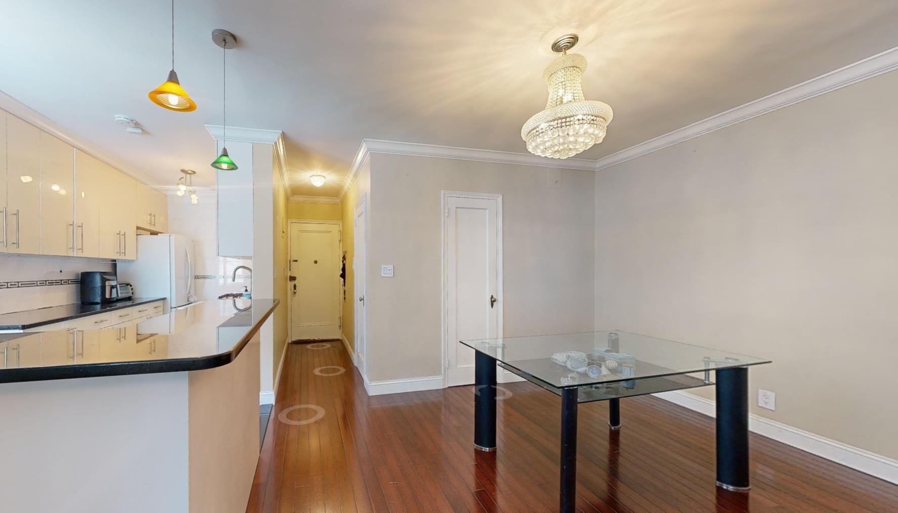 94-10 64th Road, Unit B6 Queens, NY 11374 - Photo 4 of 17 a large kitchen with a table and chairs