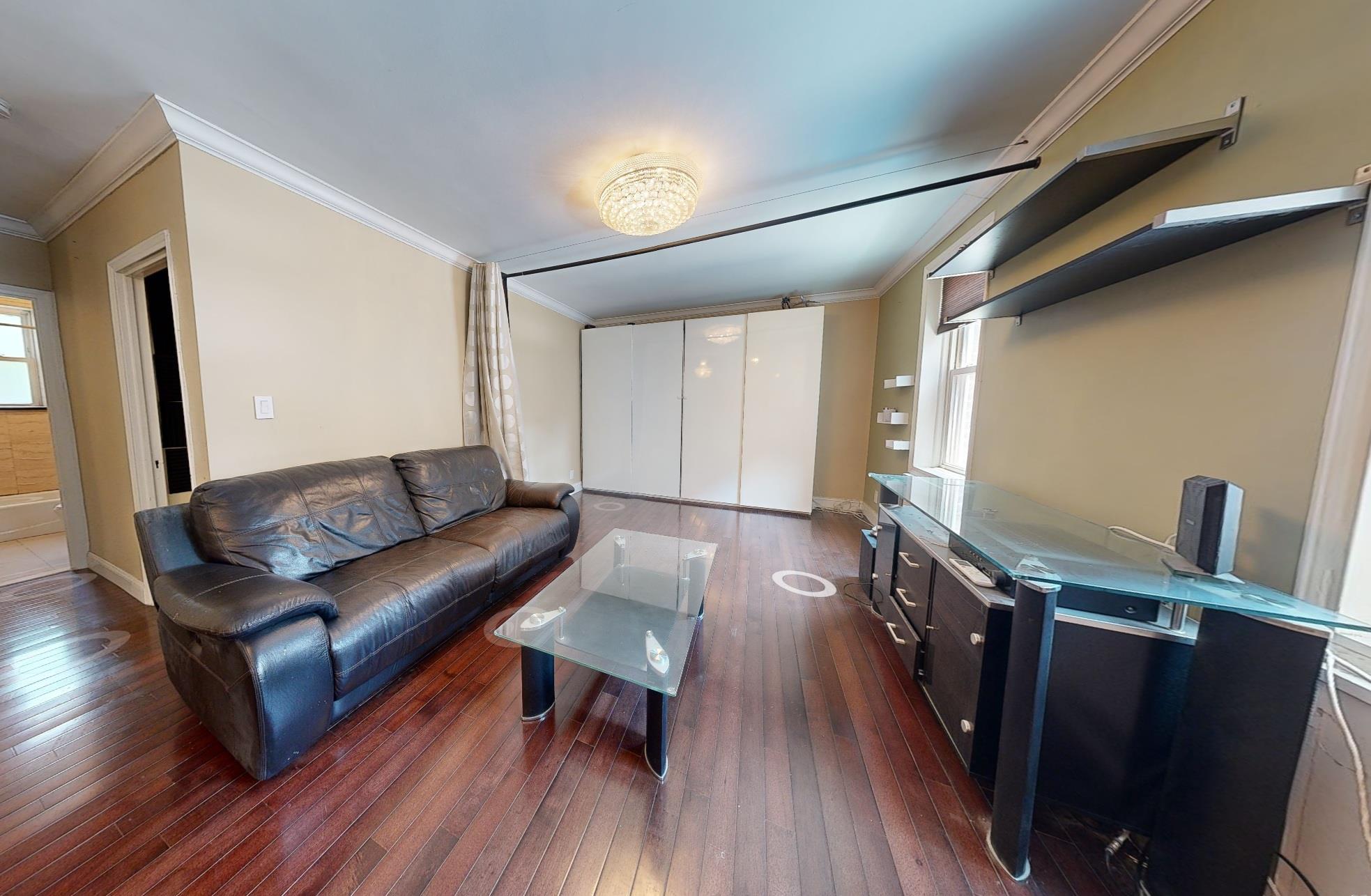 94-10 64th Road, Unit B6 Queens, NY 11374 - Photo 8 of 17 a living room with furniture and a wooden floor