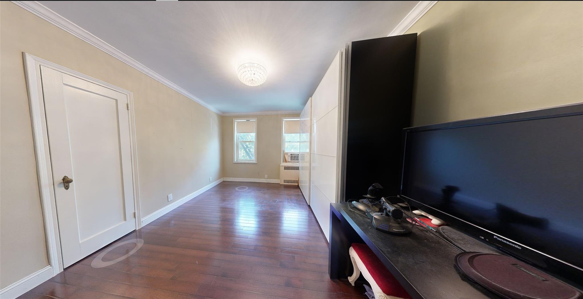 94-10 64th Road, Unit B6 Queens, NY 11374 - Photo 9 of 17 a room with furniture and wooden floor