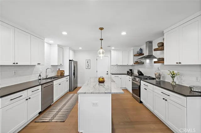 a kitchen with a sink stove cabinets and counter space