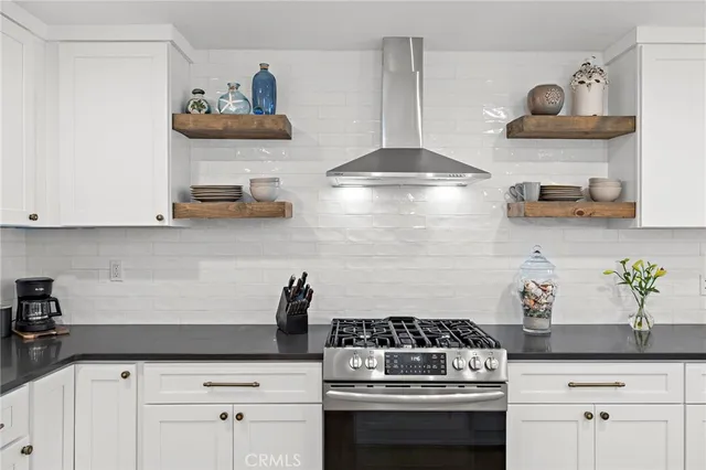 a kitchen with stainless steel appliances a stove and cabinets