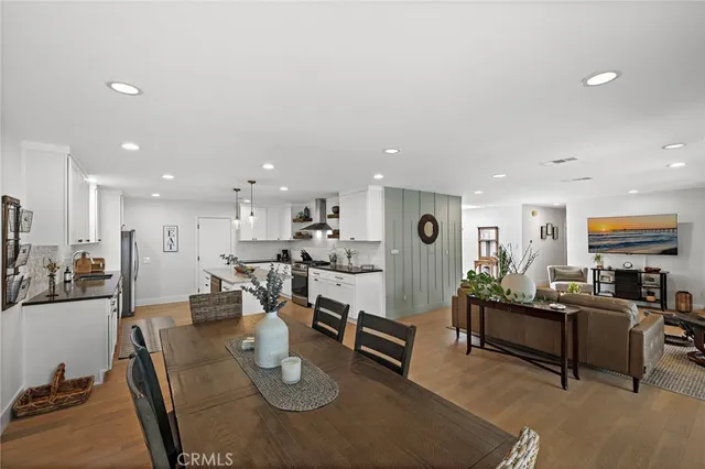 a living room with furniture kitchen view and a table