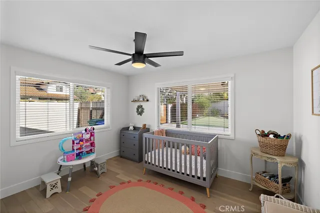 a living room with furniture stairs and a window