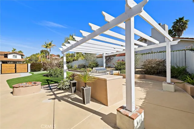 a view of a patio with table and chairs potted plants with wooden floor and fence