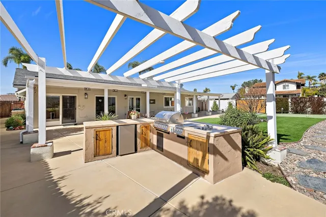 a view of a patio with couches table and chairs and potted plants
