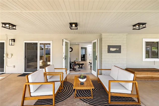 a living room with a couch and a table with wooden floor