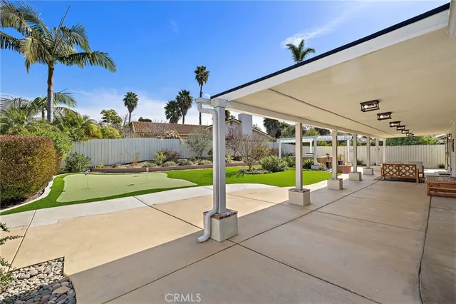 a view of a house with a swimming pool and a yard