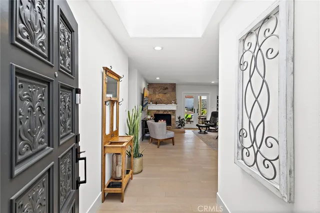 a view of a hallway with couch and chairs