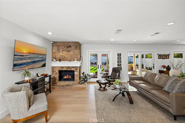 a living room with furniture a fireplace and a flat screen tv
