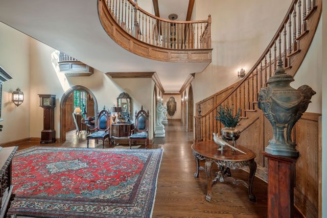 a living room with furniture fireplace and a large window