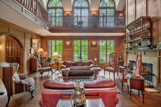 a living room with furniture a chandelier and a large window