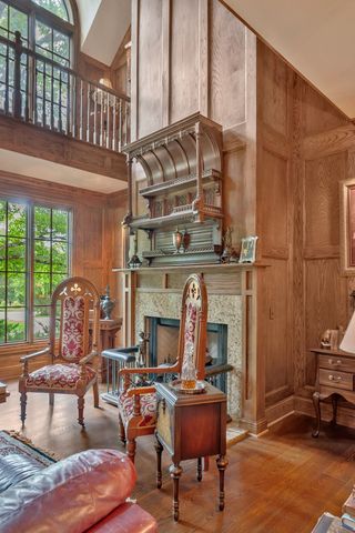 a view of staircase with a large mirror and a window