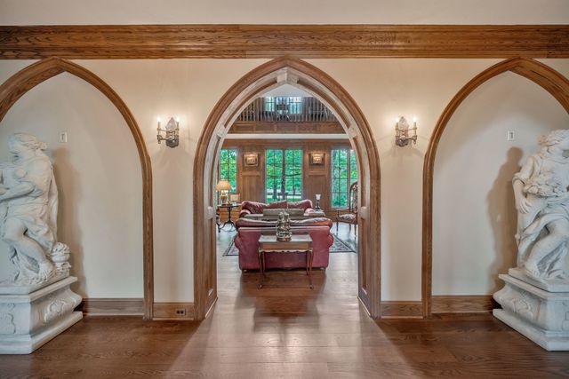 a view of a livingroom with furniture a flat screen tv and a window