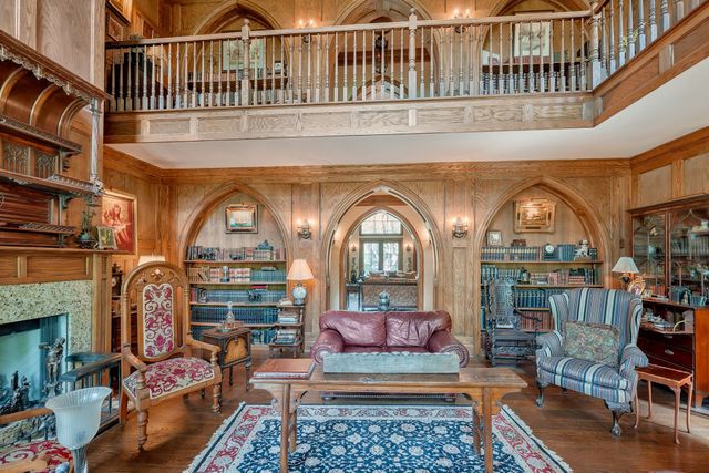 a view of staircase with railing and a chandelier