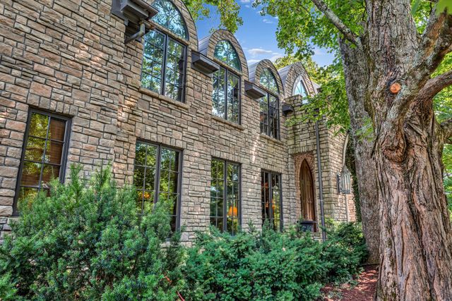 an empty room with wooden floor and a chandelier