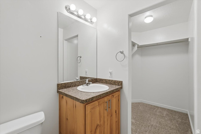 1218 Moonlight Drive Elk Ridge, UT 84651 - Photo 13 of 44 Bathroom with vanity, carpet floors, and a walk in closet