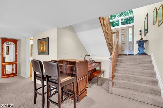 a living room with furniture a fireplace and large windows
