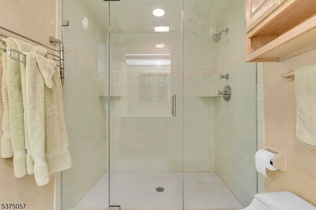 a bedroom with a bed and a lamp on dresser