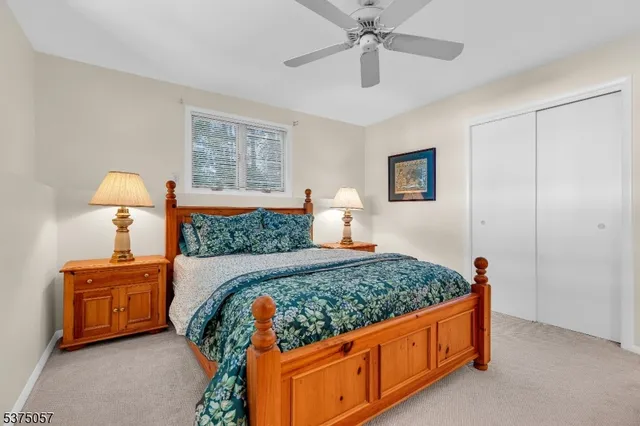 a bedroom with two beds and window