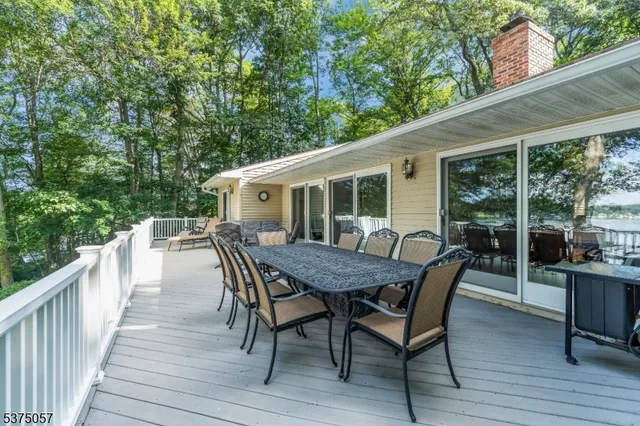 a view of a patio with couches chairs and wooden floor