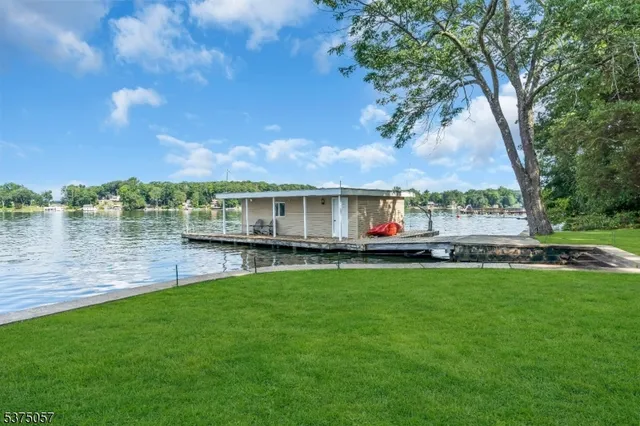 a view of a terrace with wooden floor and lake view