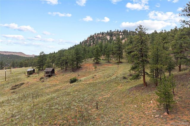 a view of a mountain range with a lush green hillside