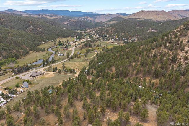 a view of a terrace with a garden and mountains