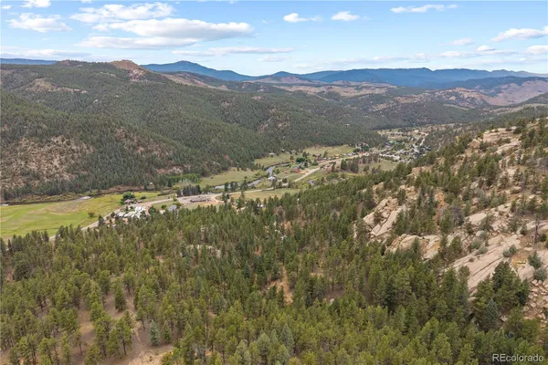 a view of a town with mountains in the background