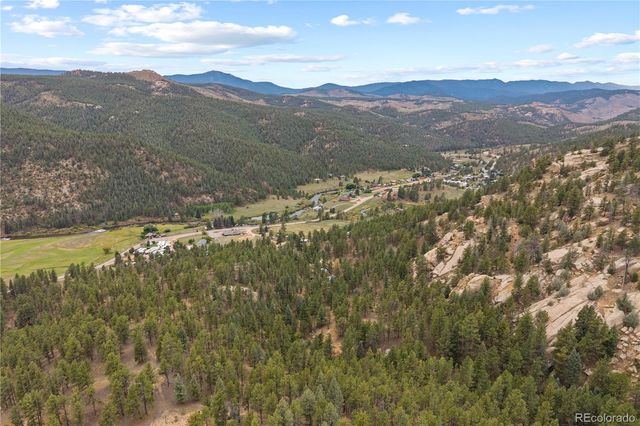 a view of a house with a swimming pool and a yard