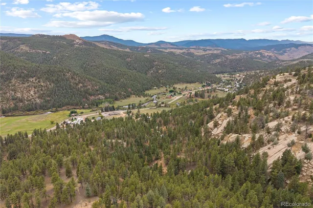 a view of a house with a swimming pool and a yard