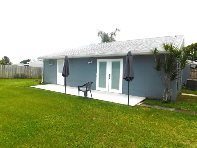 a view of a house with a yard and a porch