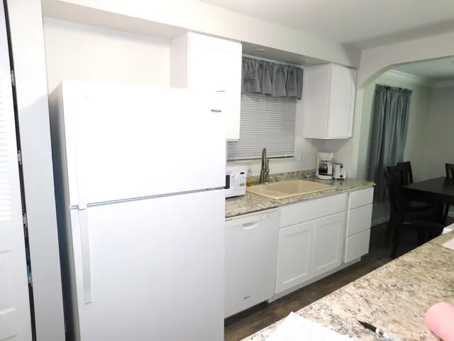 a kitchen with a sink and a refrigerator