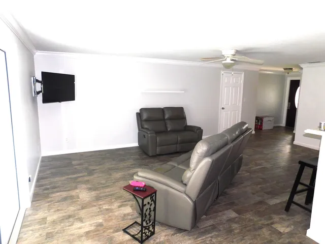 a living room with furniture and a flat screen tv
