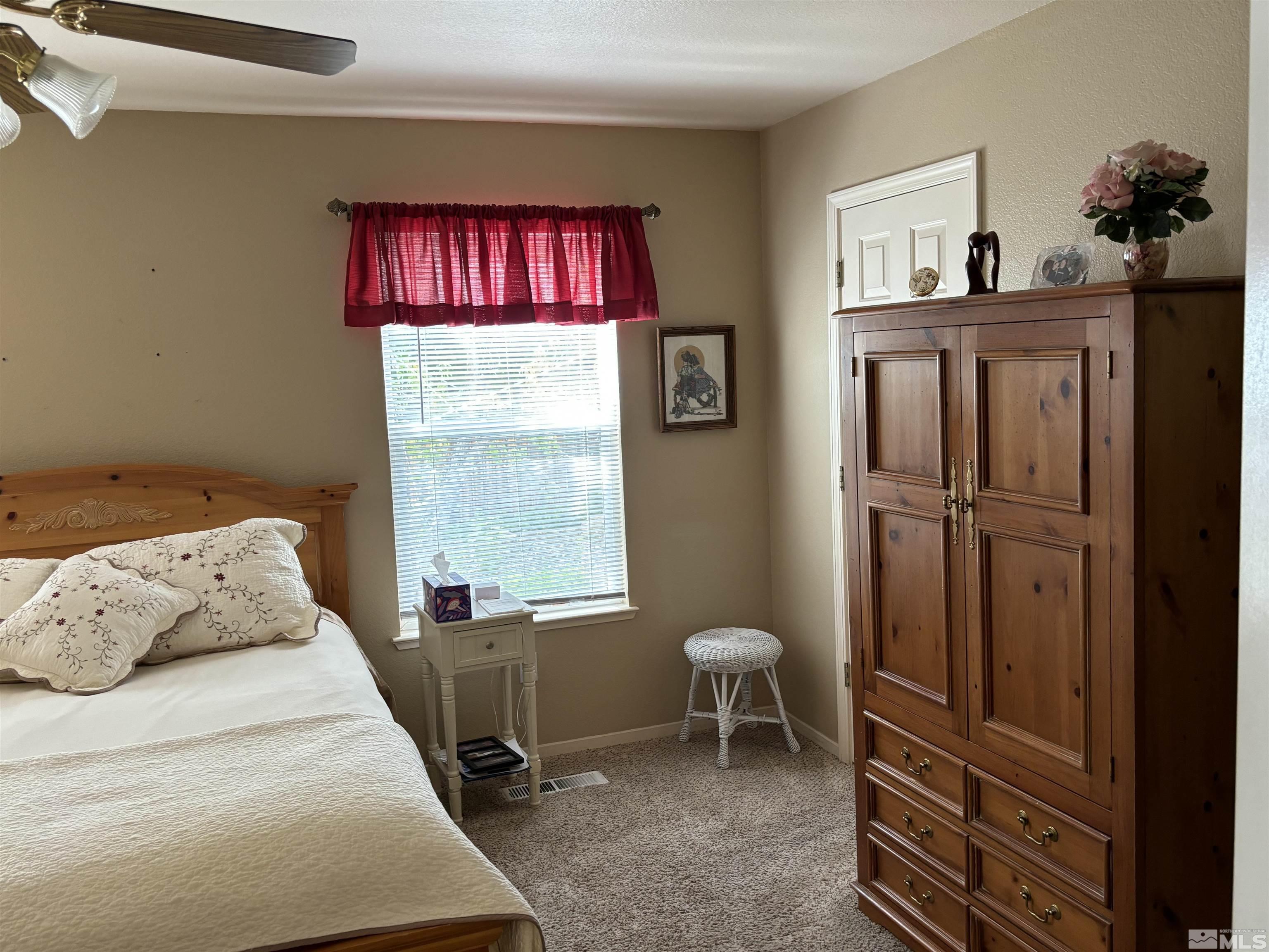 20 Ghost Rider Court Reno, NV 89511 - Photo 10 of 18 a bedroom with a bed and a window