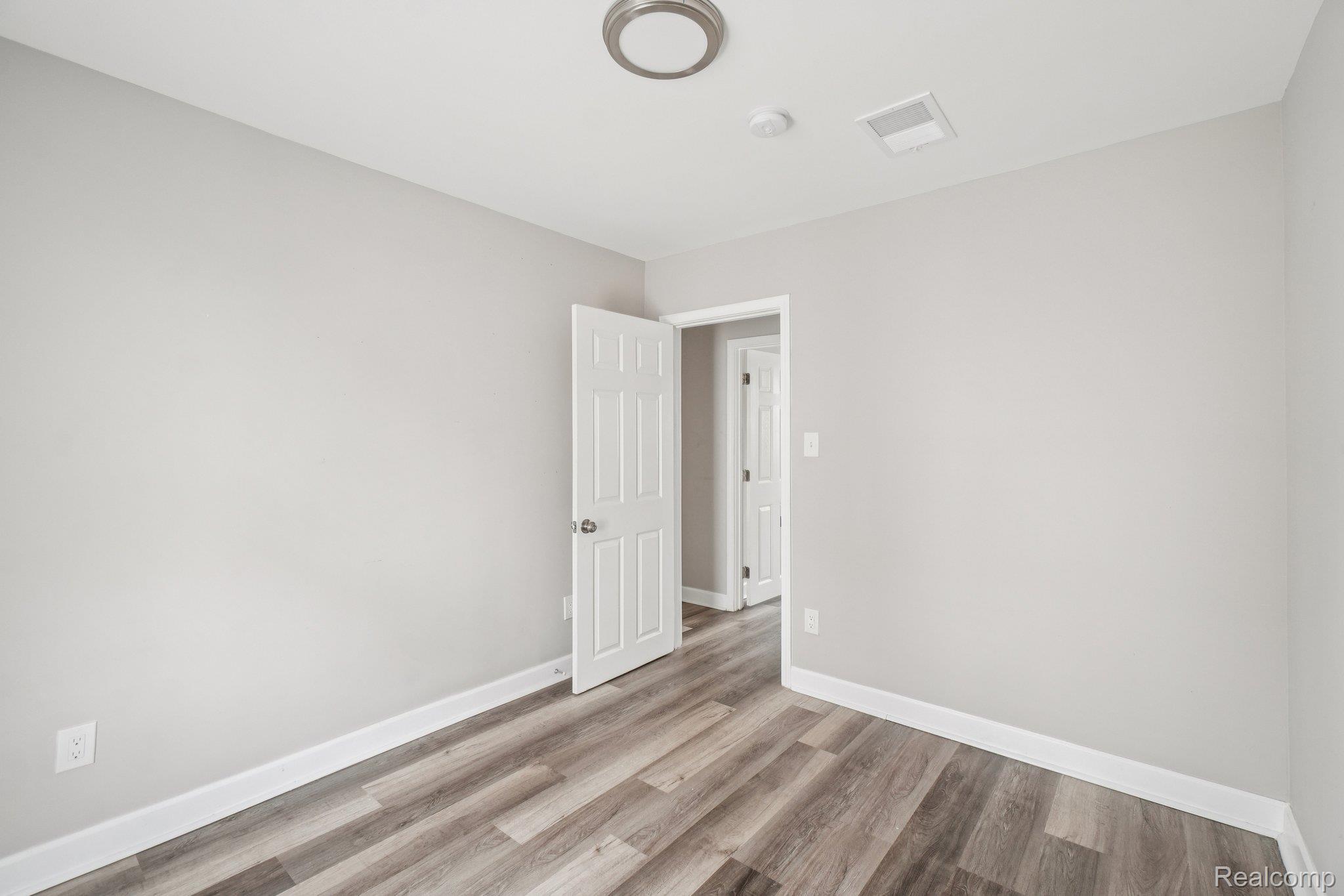 3822 Wabash Street Detroit, MI 48208 - Photo 11 of 17 Spare room featuring light wood finished floors and baseboards