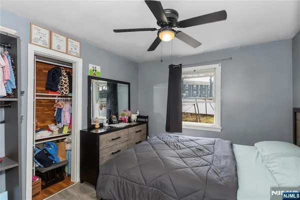 a bedroom with a bed dresser and a window