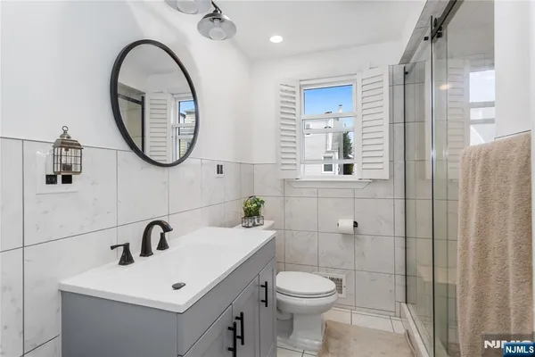 a bathroom with a toilet a sink and a mirror