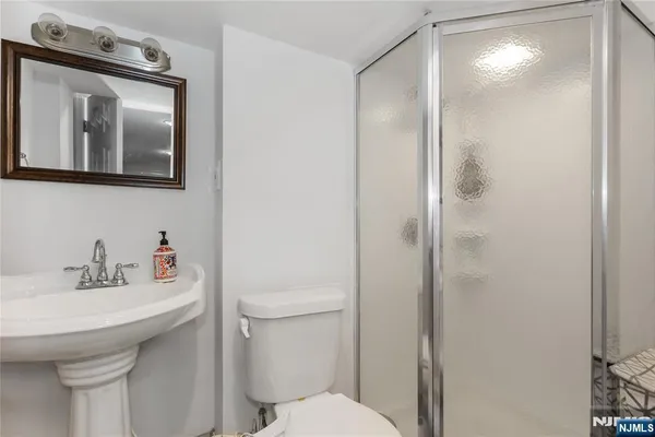 a bathroom with a sink toilet and mirror