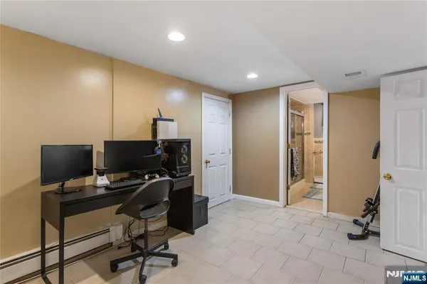 a view of a workspace with furniture and a window