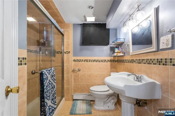 a bathroom with a toilet sink and mirror