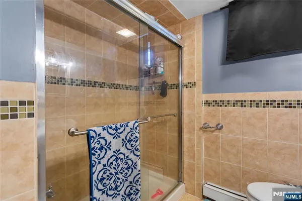 a bathroom with a shower and a sink