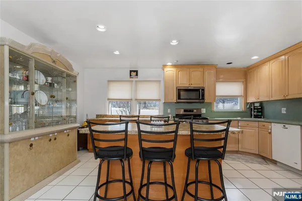 a kitchen with granite countertop a sink and white appliances